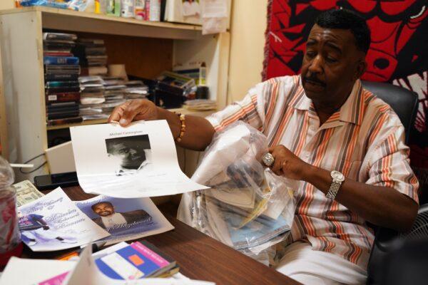 Mike Remert keeps a bag of obituaries of neighborhood people that he was acquainted with that died of drug overdoses or shootings, in his office in the West Garfield Park neighborhood in Chicago. (Cara Ding/The Epoch Times)