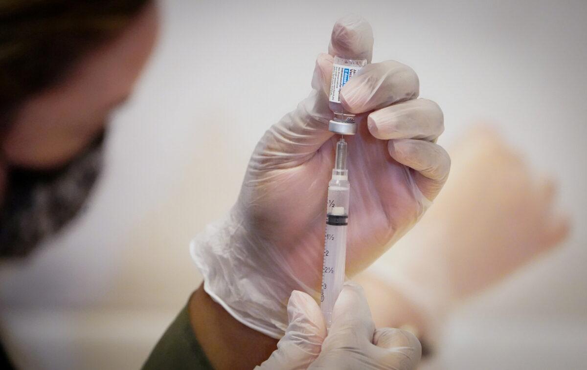 A health care worker prepares a dose of the Johnson & Johnson COVID-19 vaccine during the opening of the MTA's public vaccination program at Grand Central Terminal train station in Manhattan in New York City on May 12, 2021. (Carlo Allegri/Reuters)