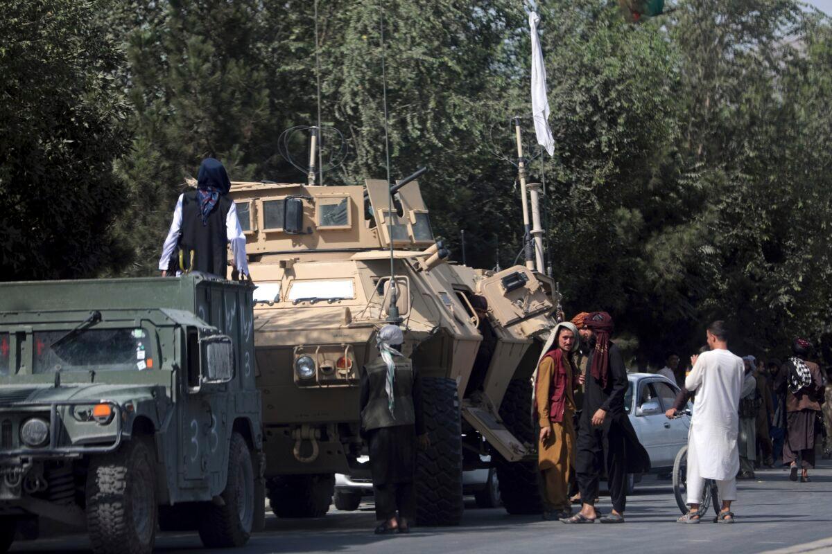 Taliban terrorists stand guard on the road to the Hamid Karzai International Airport, in Kabul, Afghanistan on Aug. 16, 2021. (Rahmat Gul/AP Photo)