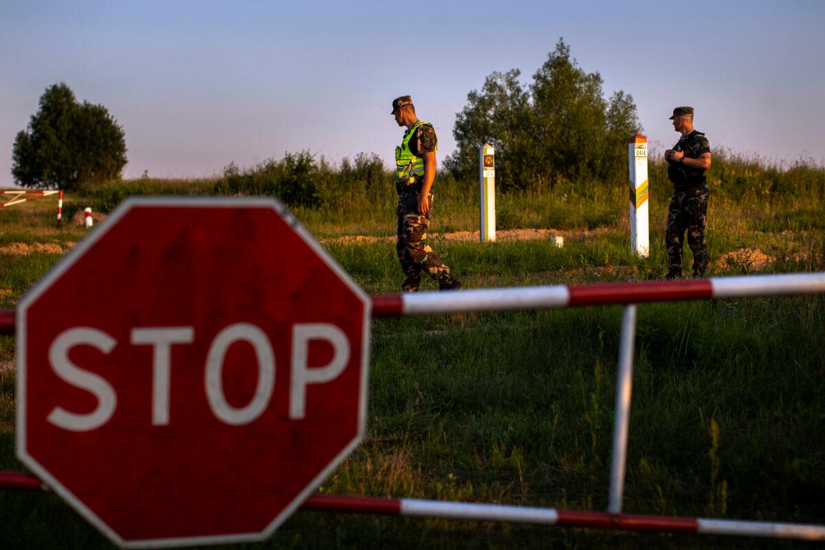 Members of the Lithuania State Border Guard Service patrol on the border with Belarus, near the village of Purvenai, Lithuania, on July 9, 2021. (Mindaugas Kulbis, File/AP Photo)