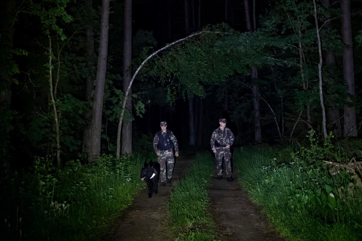 Members of the Lithuania State Border Guard Service patrol on the border with Belarus, near the small town of Kapciamiestis, some 100 miles west of the capital Vilnius, Lithuania, on June 10, 2021. (Mindaugas Kulbis/AP Photo)