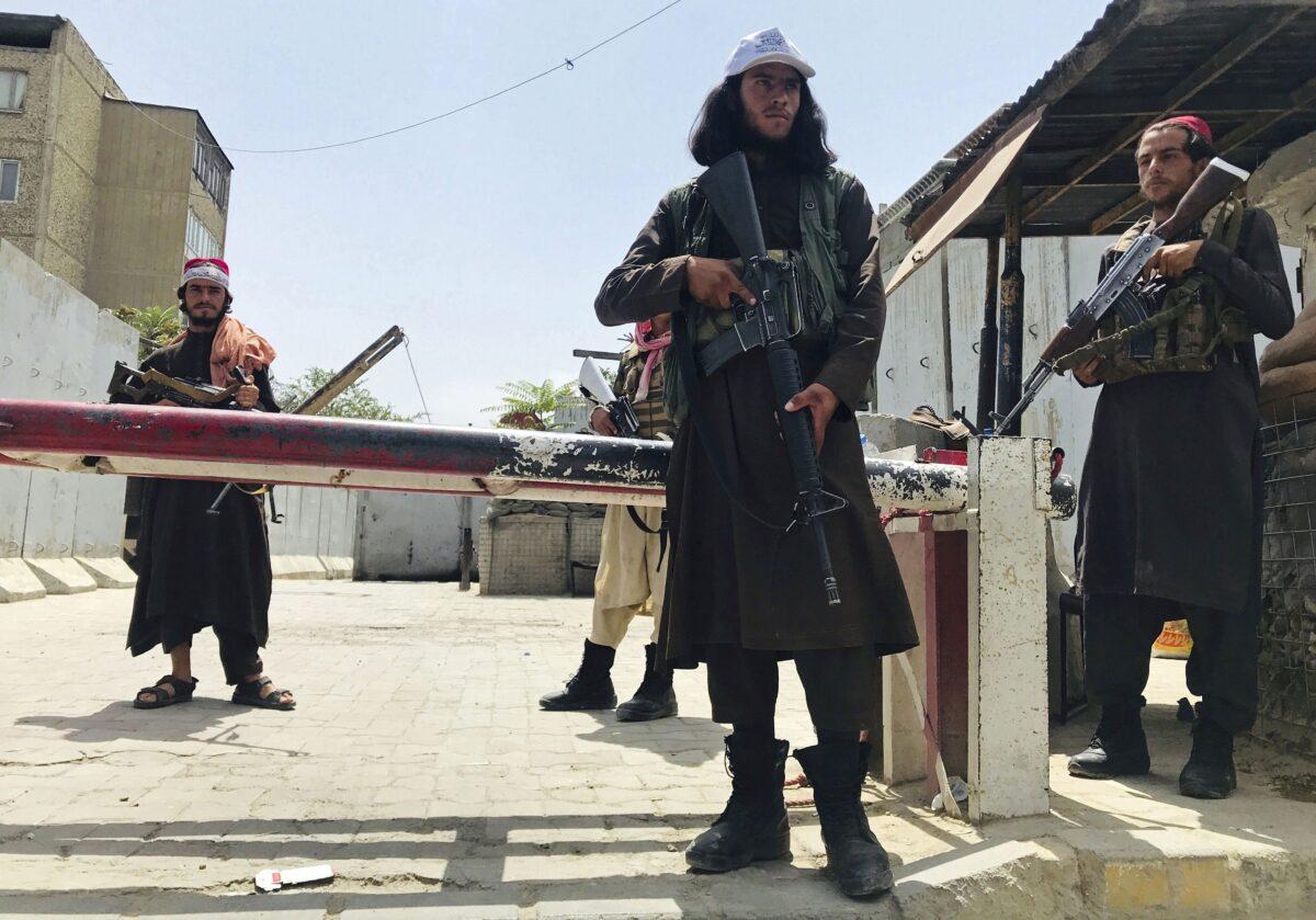 Taliban fighters stand guard at a checkpoint near the U.S. Embassy that was previously manned by American troops, in Kabul, Afghanistan, on Tuesday, Aug. 17, 2021. (AP Photo)