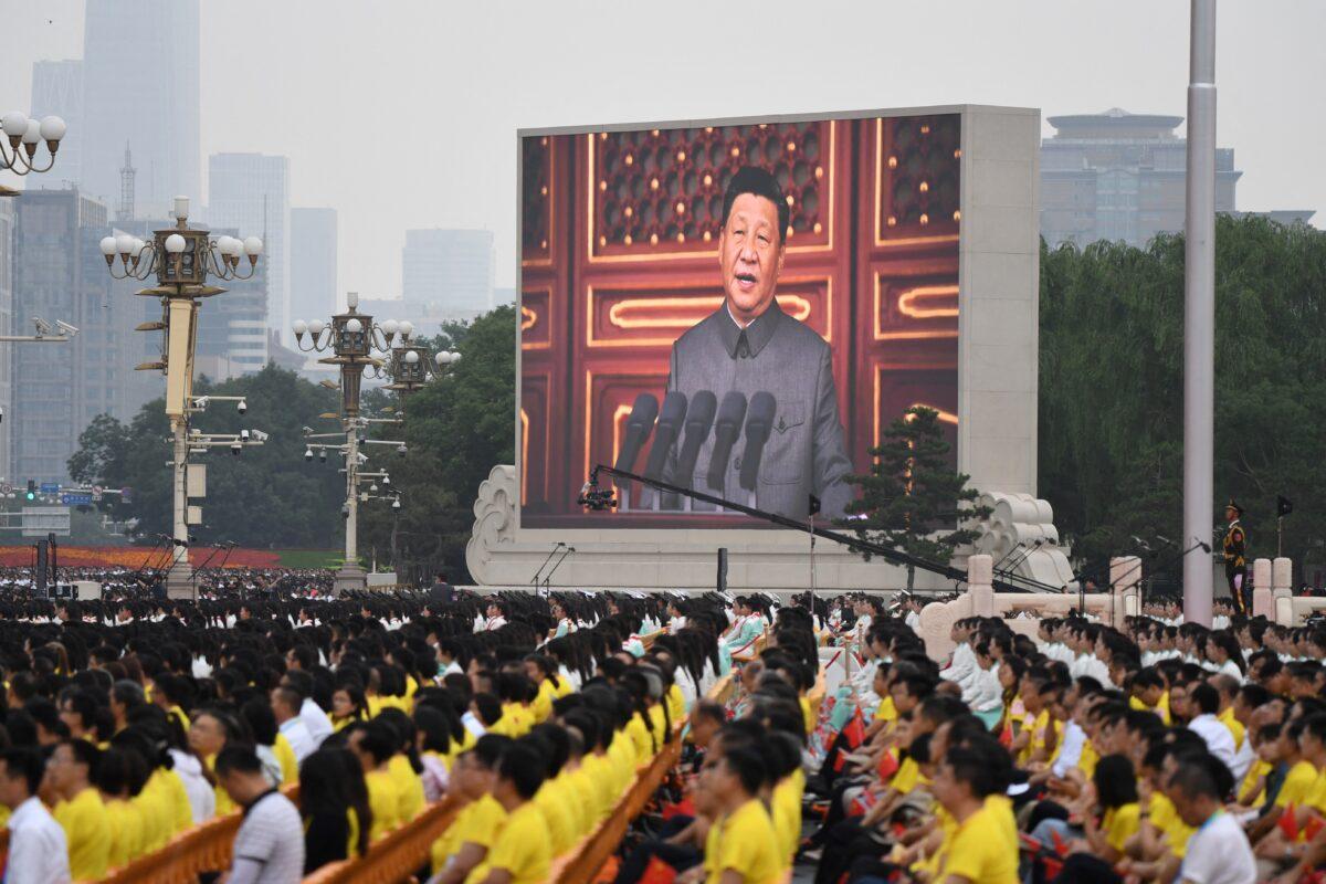 Chinese leader Xi Jinping (onscreen) delivers a speech to mark the 100th anniversary of the founding of the Chinese Communist Party at Tiananmen Square in Beijing on July 1, 2021. (Wang Zhao/AFP via Getty Images)
