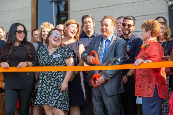 Orange Chamber of Commerce members cut a ribbon to celebrate their new offices in Orange, Calif., on Aug. 17, 2021. (John Fredricks/The Epoch Times)