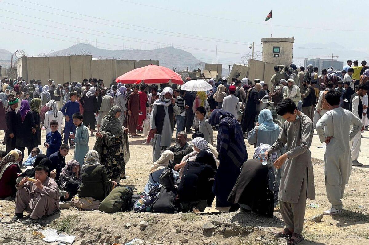 People wait outside Hamid Karzai International Airport in Kabul, Afghanistan, on Aug. 17, 2021. (Stringer/Reuters)