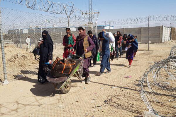 Afghan nationals cross the border into Pakistan at the Pakistan-Afghanistan border crossing in Chaman on Aug. 18, 2021. (AFP via Getty Images)