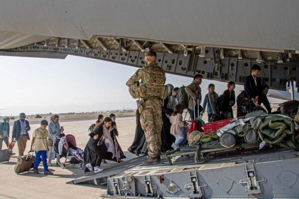 British nationals board an RAF aircraft at Kabul airport during the evacuation that followed the takeover of the city by Taliban in the city on Aug. 15, 2021. (LPhot Ben Shread/MoD/PA)
