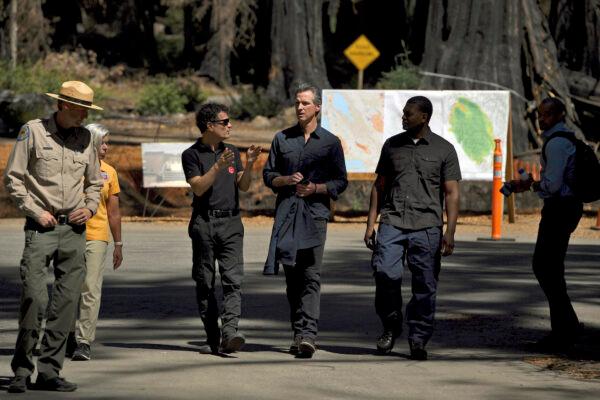 California Gov. Gavin Newsom (center) talks with Cal Fire officials at Big Basin Redwoods State Park near Boulder Creek, Calif., on Aug. 17, 2021. (AP Photo/Nic Coury)