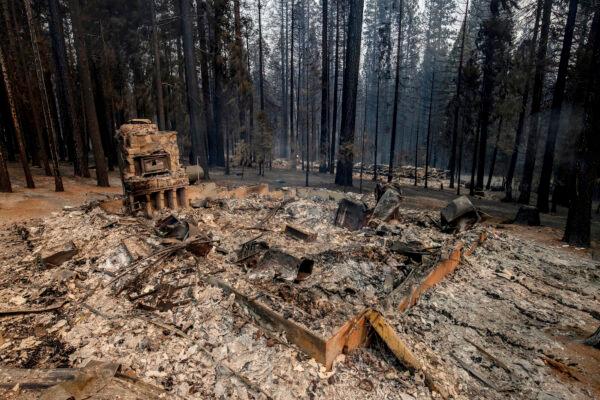 A scorched property is seen from String Canyon Road after the Caldor fire burned through Grizzly Flats, Calif., on Aug. 17, 2021. (AP Photo/Ethan Swope)