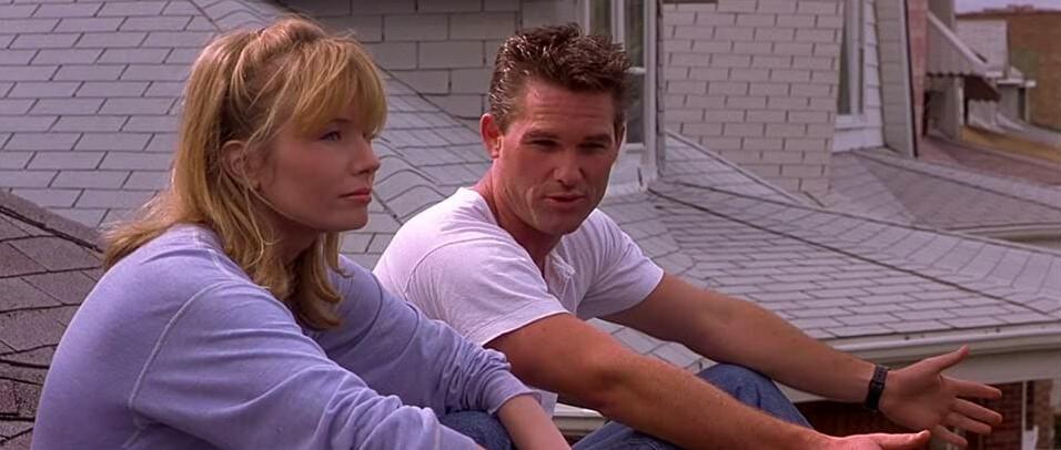 Helen McCaffrey (Rebecca De Mornay) and her fireman husband Stephen (Kurt Russell) discuss their failed marriage while sitting on their roof, in “Backdraft.” (Universal Pictures)