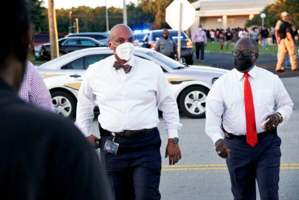 Orangeburg County School District Superintendent Shawn Foster, left, and Orangeburg County Sheriff Leroy Ravenell, right, get ready to talk to reporters after a shooting outside Orangeburg-Wilkinson High School in Orangeburg, South Carolina, on Aug. 18, 2021. (Larry Hardy/The Times and Democrat via AP)