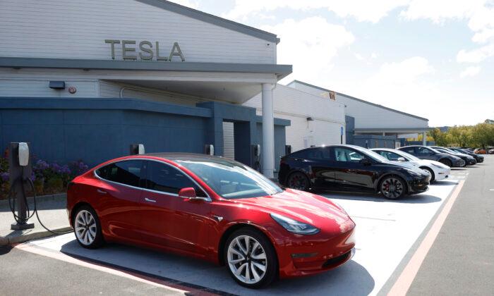 Tesla cars charge at a Tesla Supercharger station in Corte Madera, Calif., on April 26, 2021. (Justin Sullivan/Getty Images)