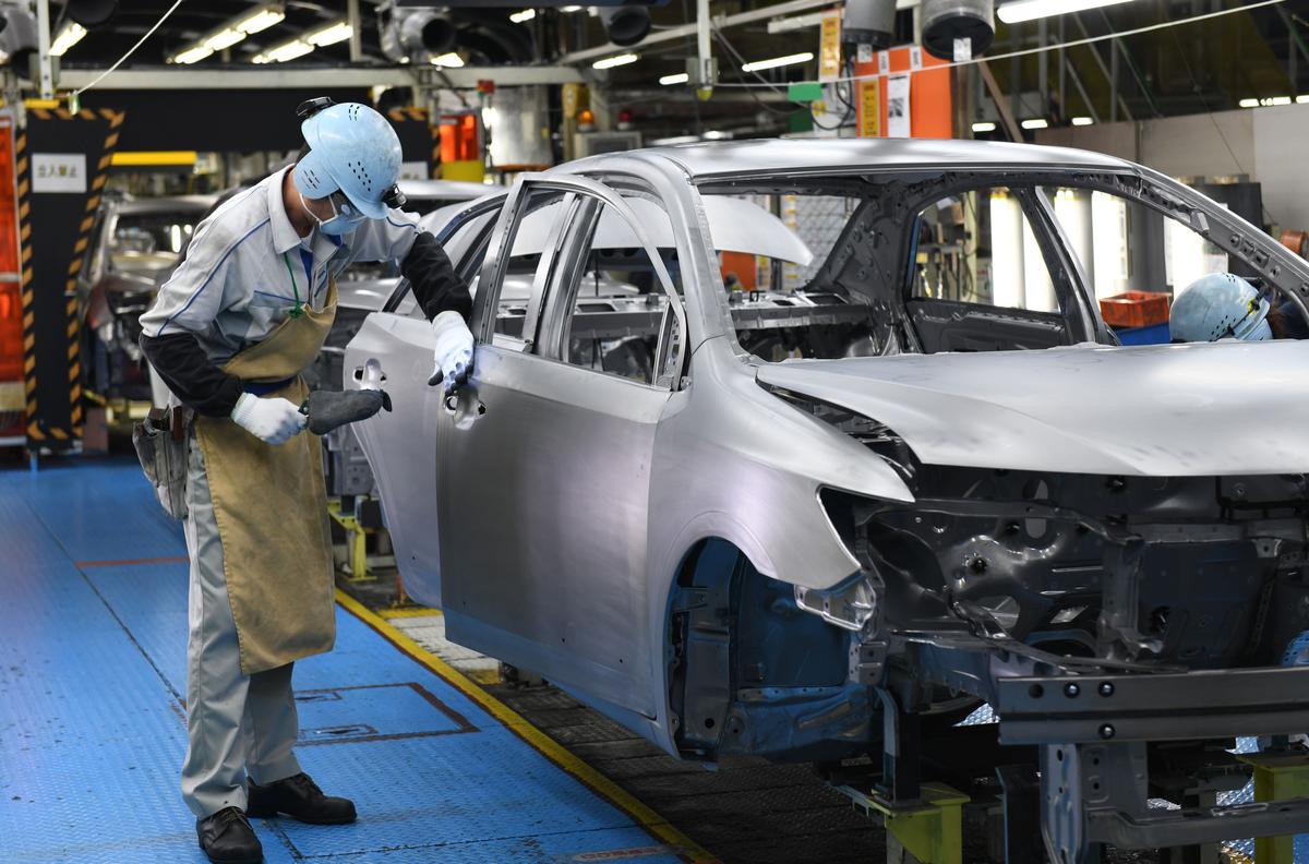 Workers assembling fourth-generation Toyota Prius cars on the production line at the company's Tsutsumi assembly plant in Toyota City, Aichi prefecture, on Dec, 8, 2017. (Toshifumi Kitamura/AFP via Getty Images)