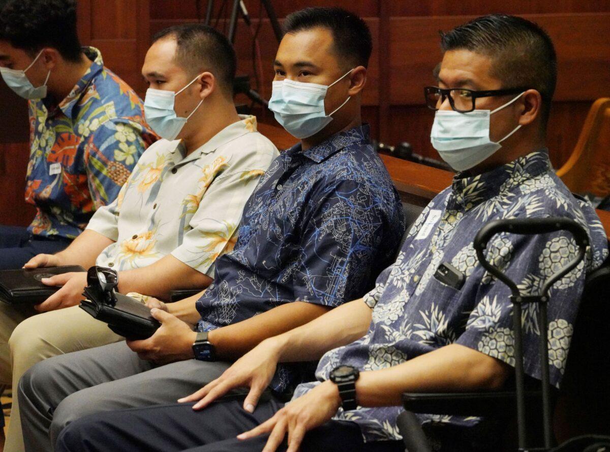 Honolulu Police Officers Geoffrey Thom (R), Christopher Fredeluces (2nd R), and Zackary Ah Nee (3rd R) sit in Judge William Domingo's courtroom before a preliminary hearing begins, in Honolulu, on July 20, 2021. (Cory Lum/Pool/File/Honolulu Civil Beat via AP)