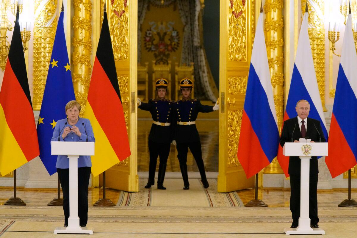Russian President Vladimir Putin and German Chancellor Angela Merkel attend a joint news conference following their talks in the Kremlin in Moscow, Russia, on Aug. 20, 2021. (Alexander Zemlianichenko/AP Photo)