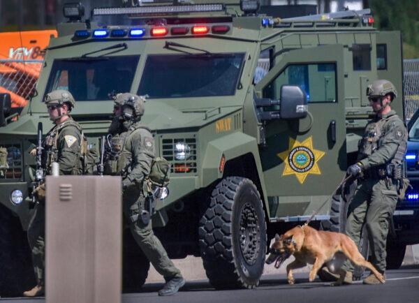 Tactical officers search for a suspect after a shootout that left multiple officers injured in northeast Albuquerque, N.M., on Aug. 19, 2021. (Robert Browman/The Albuquerque Journal via AP)