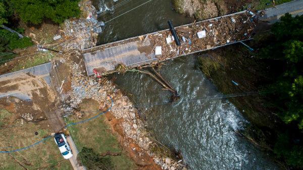 In this image taken with a drone, a flood-damaged bridge spans the Pigeon River, in Bethel, N.C., on Aug. 19, 2021. (Travis Long/The News & Observer via AP)