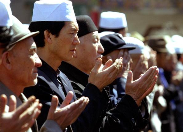 Muslim Uyghur men pray at a funeral outside a mosque in Urumqi, Xinjiang Region, China, on April, 21 2002. China has demanded the repatriation of Uyghur fighters captured alongside the Taliban in Afghanistan. China is concerned about Uyghur separatist fighting for their own country in the Northwest of China and has recently begun a crackdown in the region. Amnesty International has accused China of repression and executions of the Uyghur people in the Xinjiang Region. (Kevin Lee/Getty Images)