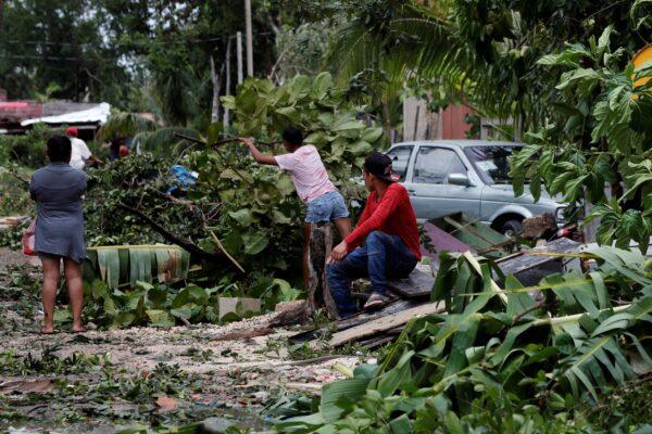 Locals remove debris from their homes after the passage of Hurricane Grace, in Tulum, Quintana Roo state, Mexico, on Aug. 19, 2021. (Marco Ugarte/AP Photo)