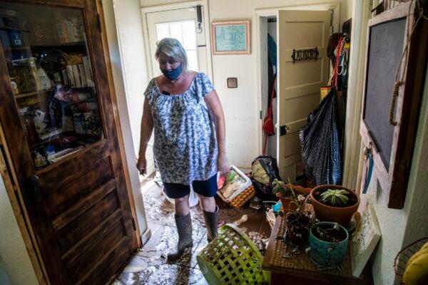 Donella Pressley looks over the flood damage to her home, in Bethel, N.C., on Aug. 19, 2021.<br/>(Travis Long/The News & Observer via AP)