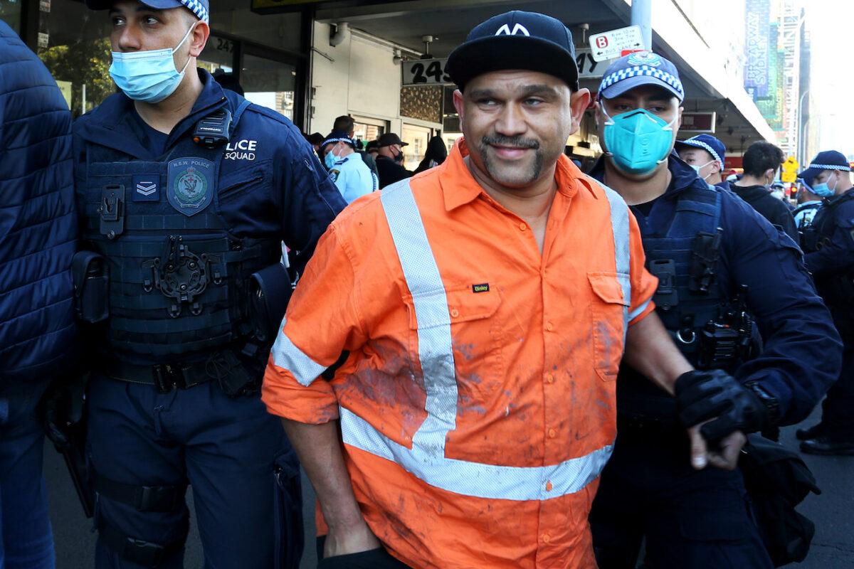 NSW Police apprehend an alleged protester in Broadway in Sydney, Australia, on Aug. 21, 2021. (Lisa Maree Williams/Getty Images)