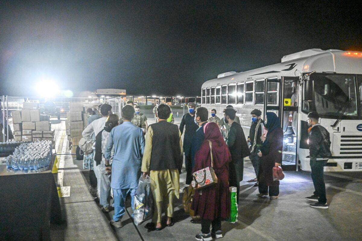 A group of Afghan evacuees departs on a bus at Ramstein Air Base, Germany on Aug. 20, 2021. (Senior Airman Jan K. Valle/U.S. Air Force via AP)