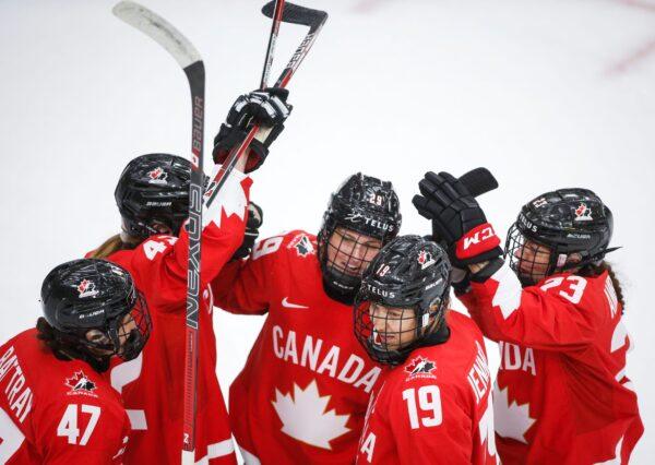 Canada's Marie-Philip Poulin (29) celebrates her goal against Finland with teammates during the second period of an IIHF women's hockey championship game in Calgary, Alberta, on Aug. 20, 2021. (Jeff McIntosh/The Canadian Press via AP)