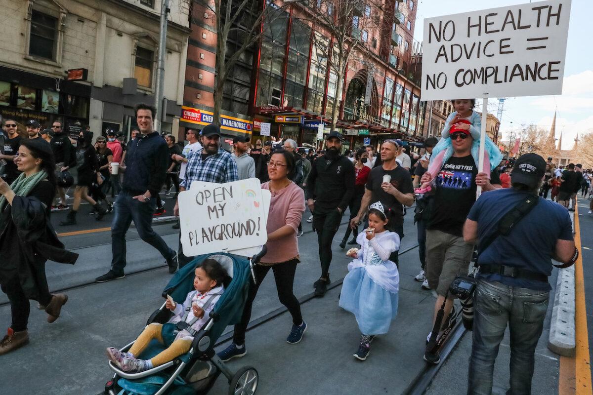 Protesters holding placards are seen marching in Melbourne, Australia, on Aug. 21, 2021. (Getty Images)