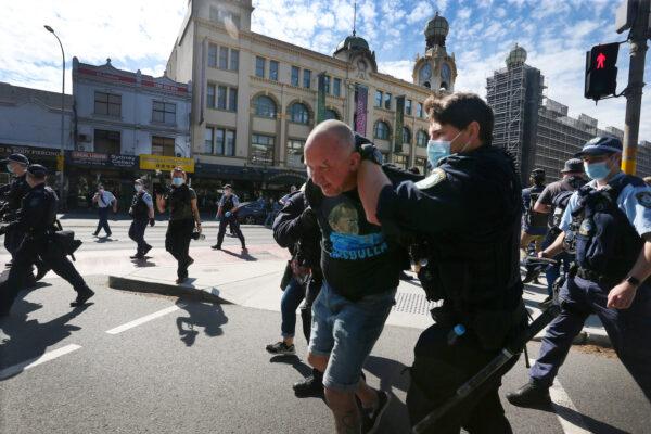 NSW Police apprehend a man who was allegedly protesting on the edge of Victoria Park in Sydney, Australia, on Aug. 21, 2021. (Lisa Maree Williams/Getty Images)