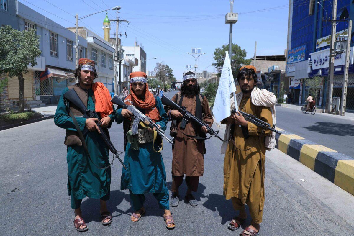 Taliban terrorists stand guard along a road near the site of an Ashura procession in Herat, Afghanistan, on Aug. 19, 2021. (Aref Karimi/AFP via Getty Images)