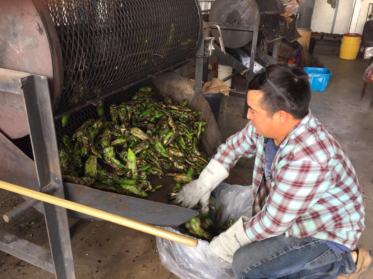 High heat, then low: Jesus Soto roasts freshly harvested Hatch green chiles at Chile Fanatic in Hatch, N.M.Every late summer to fall, local roasting stands fill the air with the thick, smoky scent of roasting chiles. (Eric Lucas)