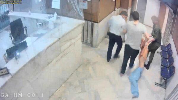 In this undated frame grab taken from video shared with The Associated Press by a self-identified hacker group called "The Justice of Ali," guards drag an emaciated prisoner, at Evin prison in Tehran, Iran. (The Justice of Ali via AP)
