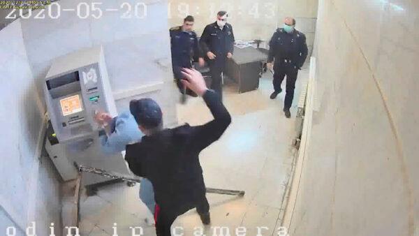 In this undated frame grab taken from video shared with The Associated Press by a self-identified hacker group called "The Justice of Ali," a guard beats a prisoner, at Evin prison in Tehran, Iran. (The Justice of Ali via AP)