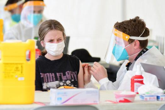 A 12-year-old girl receives her COVID-19 vaccine at a vaccination hub in Dubbo, Australia, on Aug. 21, 2021. (Belinda Soole/Getty Images)
