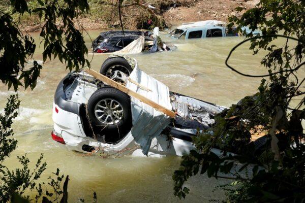 Vehicles come to rest in a stream in Waverly, Tenn., on Aug. 22, 2021. (Mark Humphrey/AP Photo)