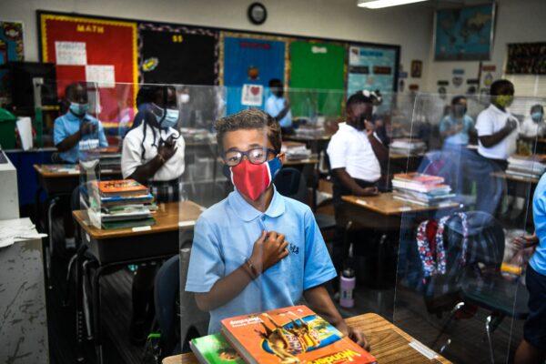 Students wear masks as they attend their first day in school after summer vacation at the St. Lawrence Catholic School north of Miami, on Aug. 18, 2021. (Chandan Khanna/AFP via Getty Images)