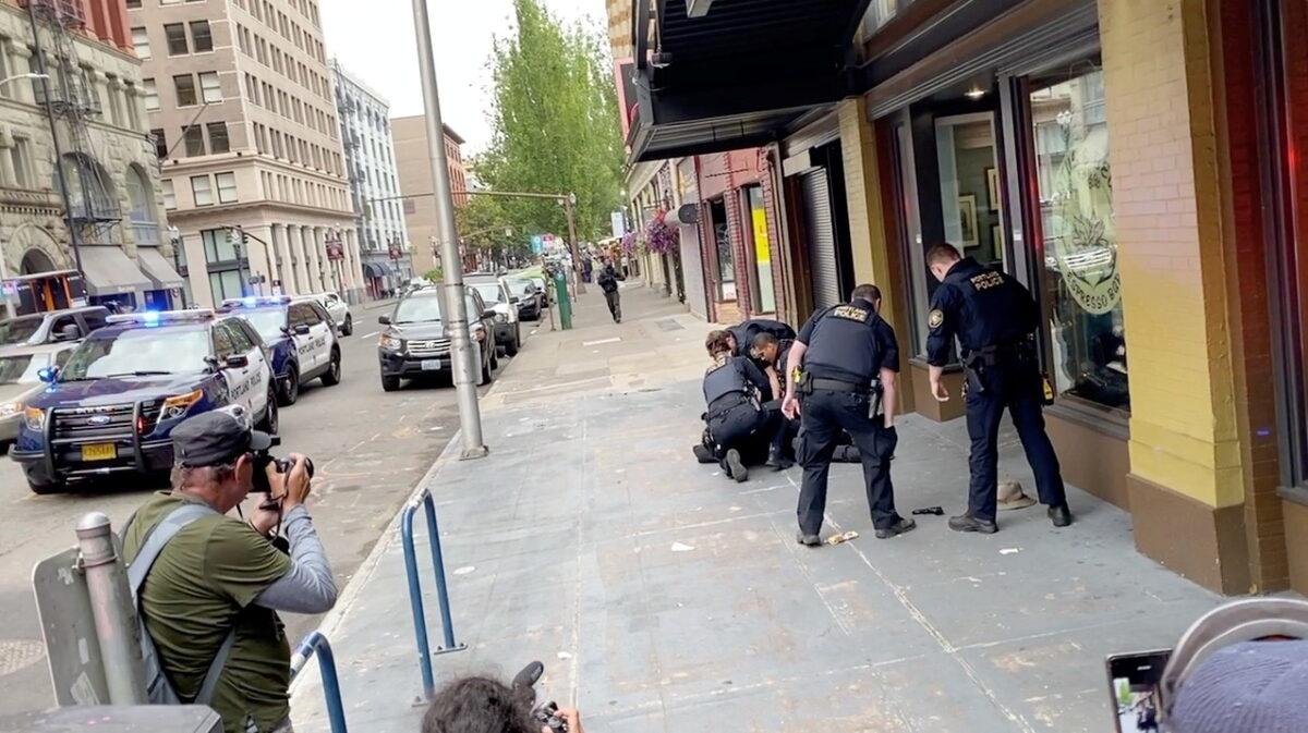 Police officers detain a man who opened fire with a handgun in Portland, Ore., on Aug. 22, 2021. (Courtesy of Alix Powell @thatpowellgirl via Reuters)