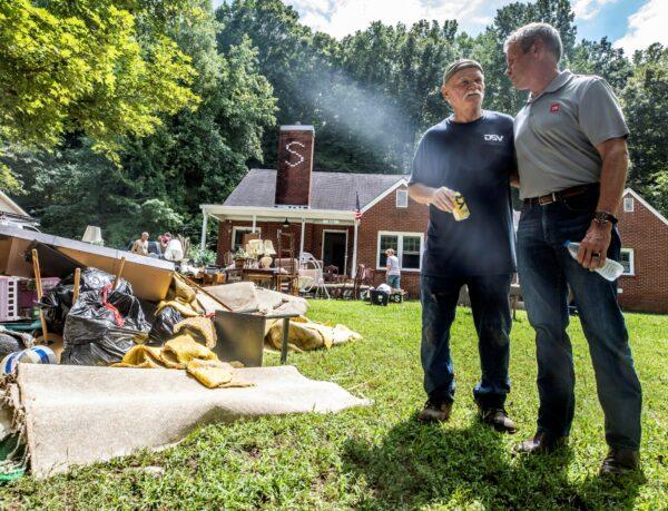 Tennessee Gov. Bill Lee (R) talks with Joseph Mroczkowski during a tour of areas that suffered damage from catastrophic floods in Waverly, Tenn., on Aug. 22, 2021. (Alan Poizner-Pool/Getty Images)