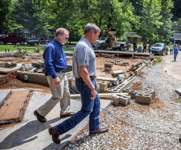 Tennessee Gov. Bill Lee (R) walks past a home swept off its foundation in catastrophic floods in Waverly, Tenn., on Aug. 22, 2021. (Alan Poizner-Pool/Getty Images)