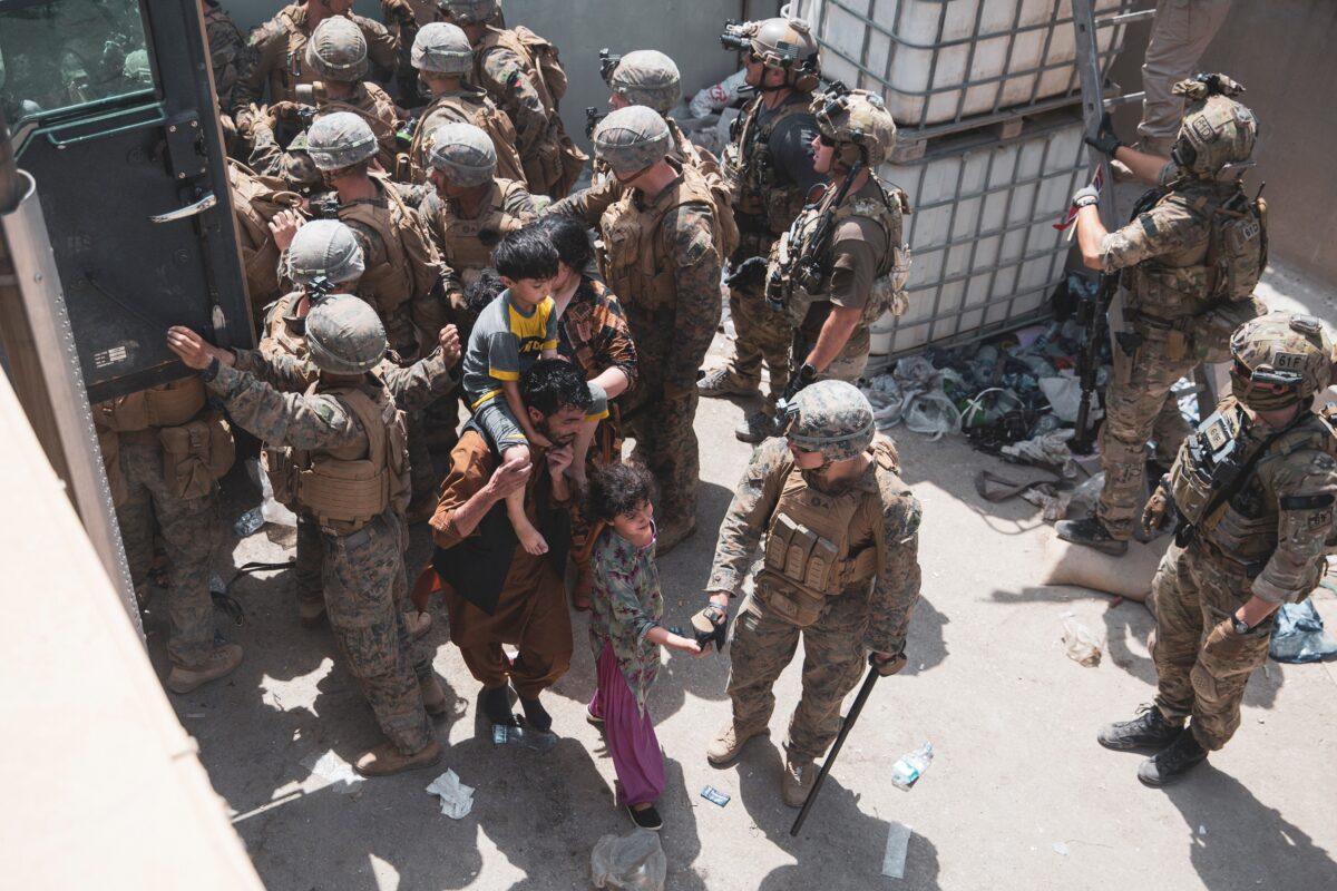 U.S. Marines and Norwegian coalition forces assist with security at an Evacuation Control Checkpoint ensuring evacuees are processed safely during an evacuation at Hamid Karzai International Airport in Kabul, Afghanistan, on Aug. 20, 2021. (U.S. Marine Corps/Staff Sgt. Victor Mancilla)
