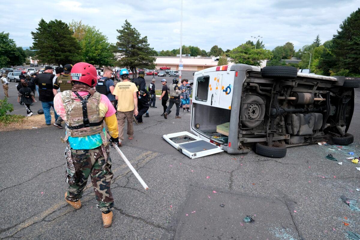 A van that was driven by Antifa members is pictured flipped on its side with all windows smashed after it was driven into a Proud Boys rally in Portland, Ore., on Aug. 22, 2021. (Alex Milan Tracy/AP Photo)