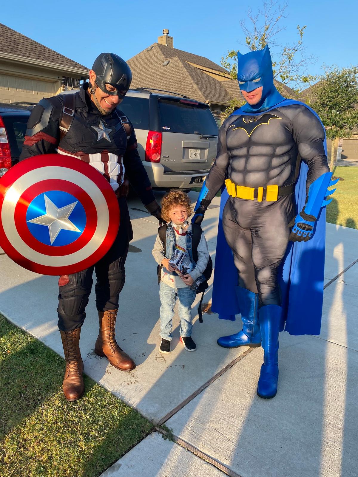 Michael being escorted to the school by the Midlothian fire department with Captain America and Batman. (Courtesy of <a href="https://www.facebook.com/brittanydenisonrealtor">Brittany Denison</a>)