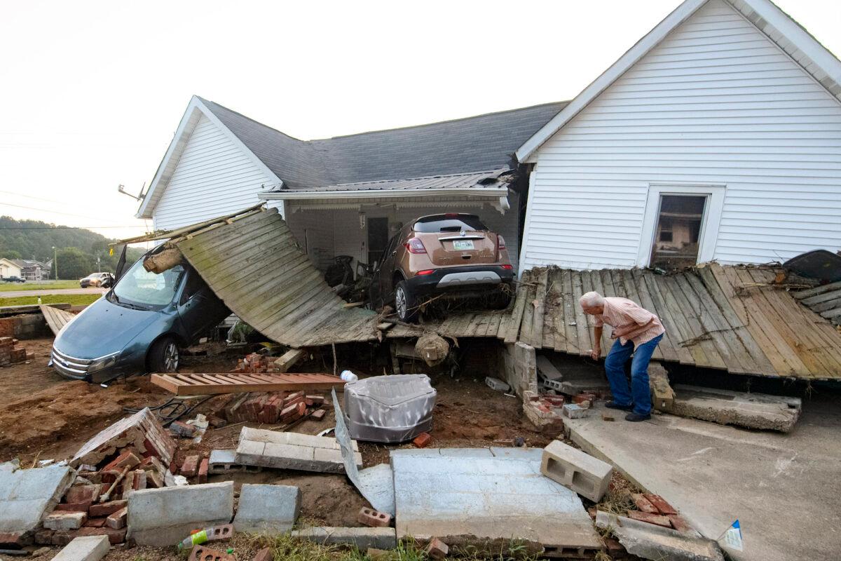 A man examines flood damage to his granddaughter’s house in Waverly, Tenn., on Aug. 23, 2021. (John Amis/AP Photo)
