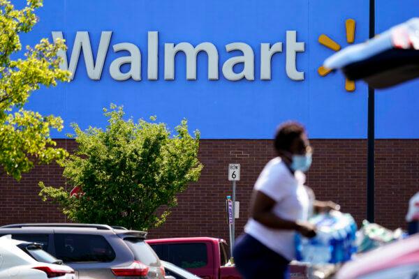 A shopper loads items into her car in the parking lot of a Walmart in Willow Grove, Pa., on May 19, 2021. (Matt Rourke/AP Photo)