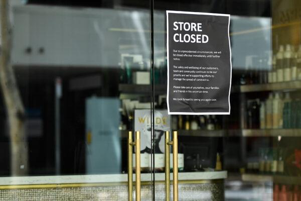 A "Store closed" sign is seen on the window of a business in the CBD of Brisbane, Australia, on Jan. 11, 2021. (AAP Image/Albert Perez)