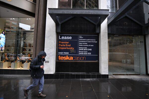 A person is seen walking past a for lease sign on a building in Melbourne, Australia, on June 8, 2021. (AAP Image/James Ross)