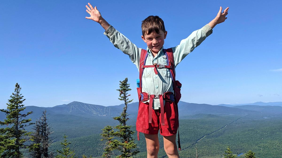 Harvey Sutton raises his arms on a mountaintop in Bigelow Preserve, Maine, while hiking the Appalachian Trail with his mom and dad. (Joshua Sutton/AP Photo)