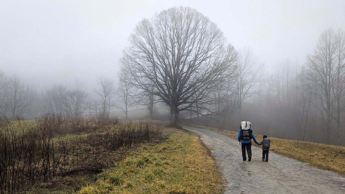 Harvey Sutton (R) walks hand and hand with his dad, Joshua, near Hot Springs, North Carolina, on Feb. 12, 2021, while hiking the Appalachian Trail with his mom and dad. (Joshua Sutton/AP Photo)