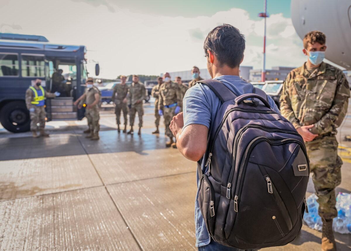 An evacuee from Afghanistan walks toward a transportation bus after landing at Ramstein Air Base, Germany, on Aug. 22, 2021. (Air Force/Senior Airman Jan K. Valle/Handout via Reuters)