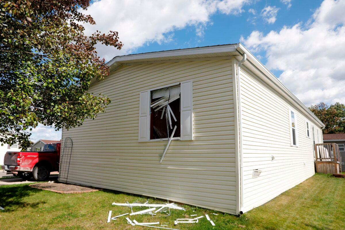 A broken window is seen on a home in connection with a plot to kidnap Michigan Governor Gretchen Whitmer, at a Hartland Township mobile home park in Heartland, Mich., on Oct. 8, 2020. (Jeff Kowalsky/AFP via Getty Images)